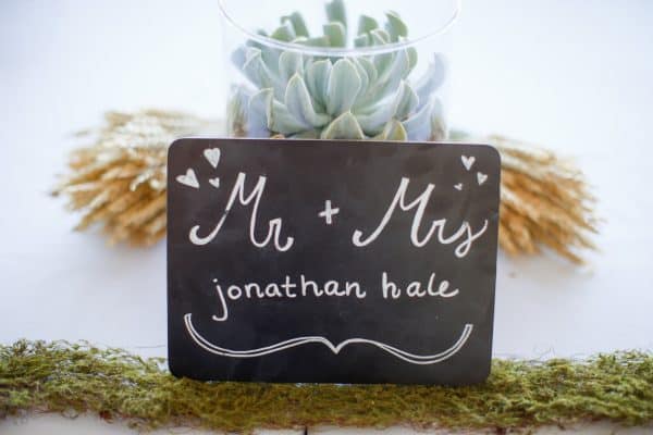 Mr and Mrs chalkboard sign, centerpiece on head table at wedding | DuctTapeAndDenim.com