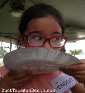 Our littlest vendor at Antique Alley flea market, licking powdered sugar from her funnel cake | DuctTapeAndDenim.com