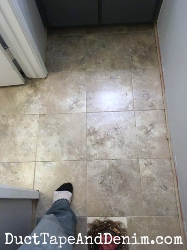 Finished vinyl tile floor in the powder room | DuctTapeAndDenim.com