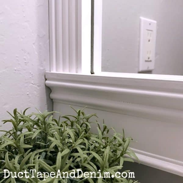 Close up of completed DIY bathroom mirror frame in our small guest powder room | DuctTapeAndDenim.com