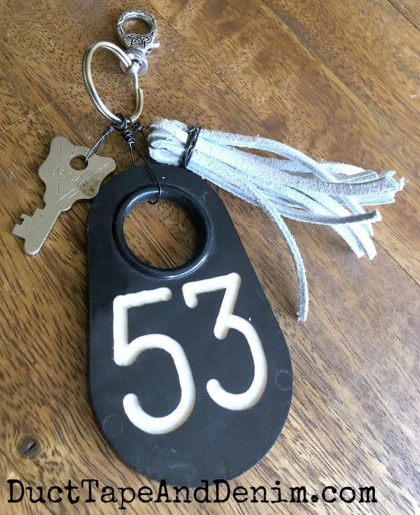 old cow tag, key, leather tassel on a purse charm key chain DuctTapeAndDenim.com