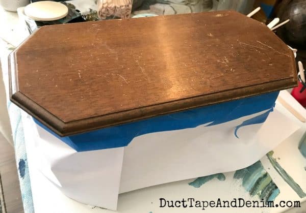 Taping off top of jewelry box to do a paint pour
