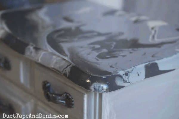 close up of paint pour on top of gray jewelry box