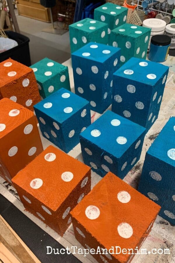 4 x 4 scrap wood pieces painted turquoise teal and orange with white polka dots