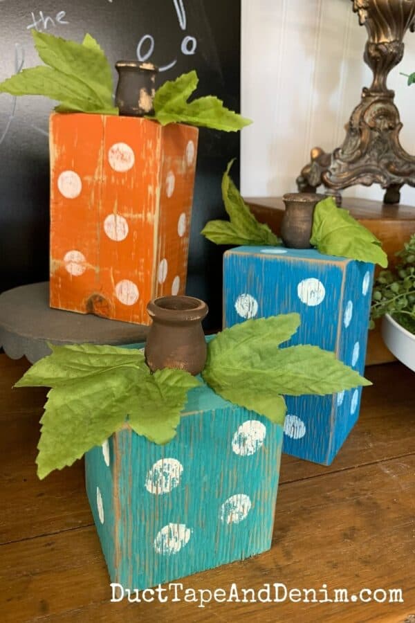 set of three wooden pumpkin candle holders with polka dots