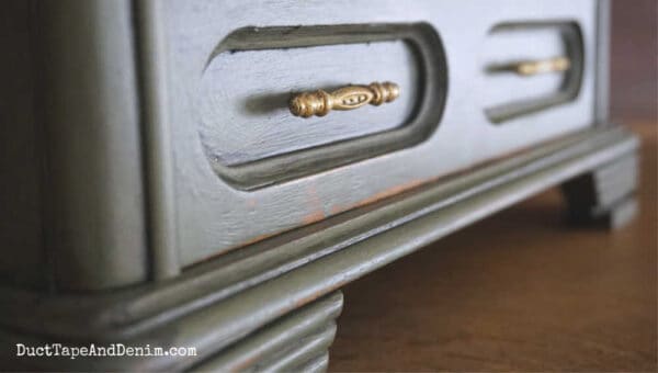 close up of green jewelry box drawer and gold handle 