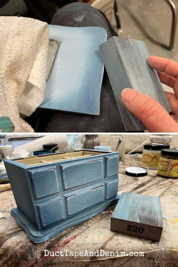 sanding distressed paint finish on old blue jewelry boxes